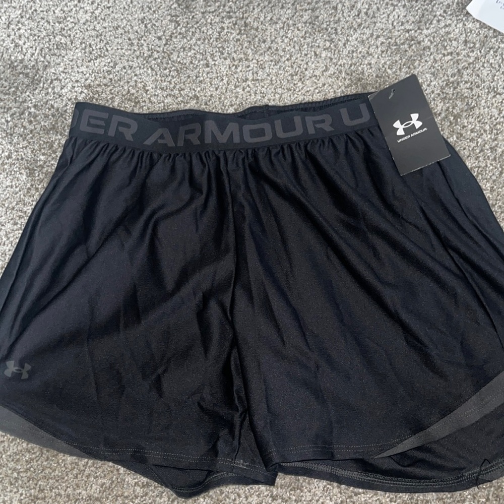 Woman’s under armour black shorts . Medium new in package